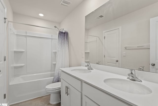 full bathroom featuring toilet, shower / bath combo with shower curtain, a sink, and visible vents