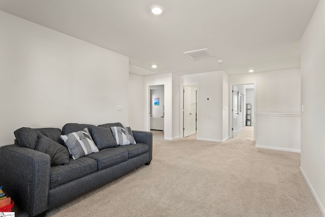 living room with recessed lighting, visible vents, baseboards, and light colored carpet