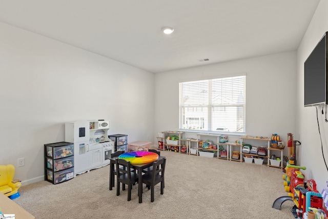 recreation room with carpet floors and visible vents