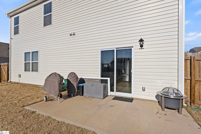 back of property featuring a patio and fence