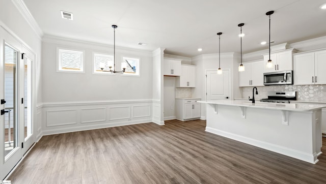 1807 Wabash Pl Lot 0507, Boiling Springs, SC 29316 - kitchen with appliances with stainless steel finishes, dark wood-type flooring, light countertops, a chandelier, and ornamental molding