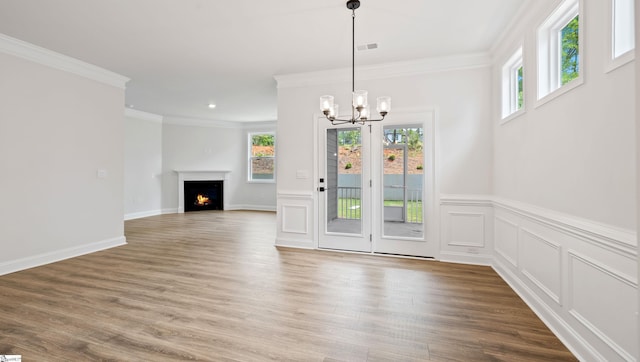 1807 Wabash Pl Lot 0507, Boiling Springs, SC 29316 - unfurnished dining area with a chandelier, ornamental molding, wood finished floors, a warm lit fireplace, and a wainscoted wall