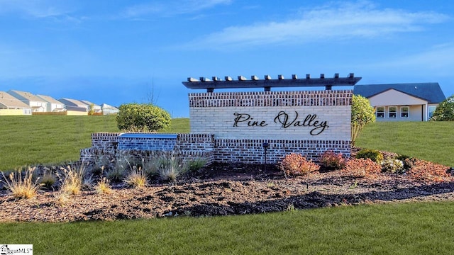 community / neighborhood sign with a lawn