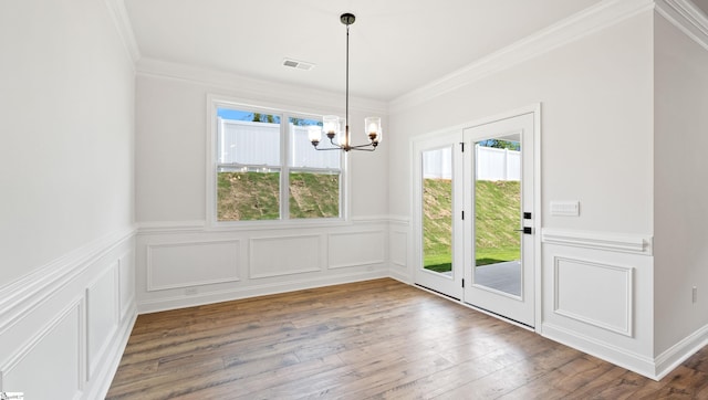 1791 Wabash Pl Lot 0511, Boiling Springs, SC 29316 - unfurnished dining area featuring a chandelier, healthy amount of natural light, a wainscoted wall, ornamental molding, and hardwood / wood-style floors