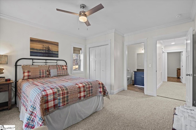 carpeted bedroom with ceiling fan, ornamental molding, a closet, and baseboards