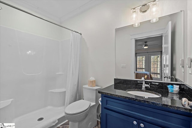 full bathroom with a stall shower, vanity, toilet, and crown molding