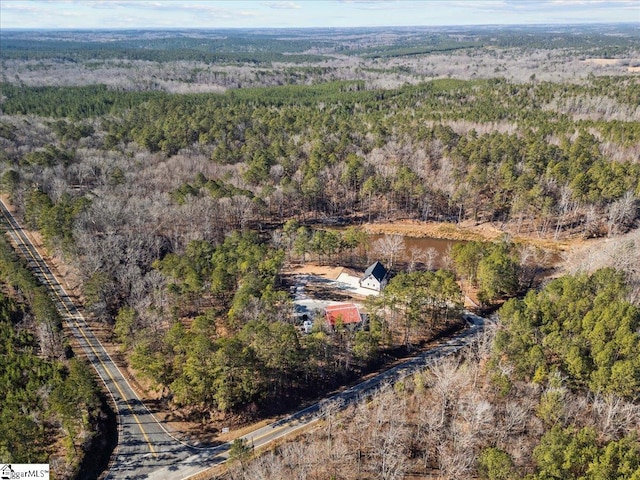 drone / aerial view featuring a wooded view