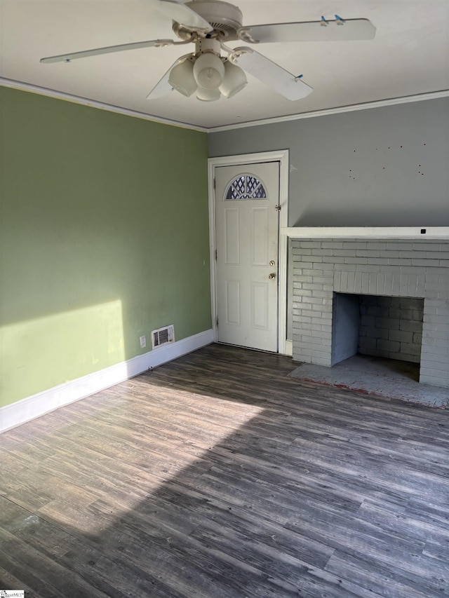 unfurnished living room featuring a fireplace, visible vents, crown molding, and wood finished floors