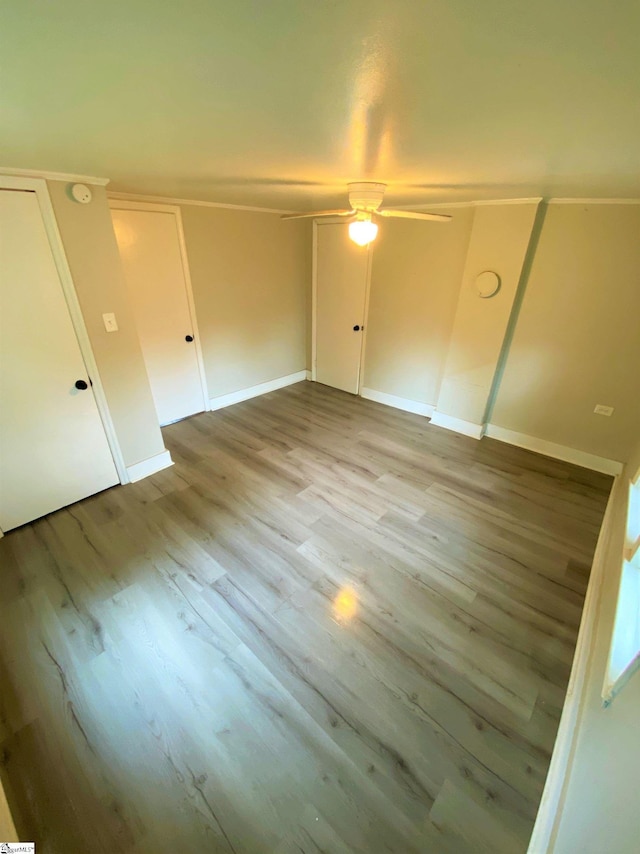 unfurnished bedroom with wood finished floors and baseboards