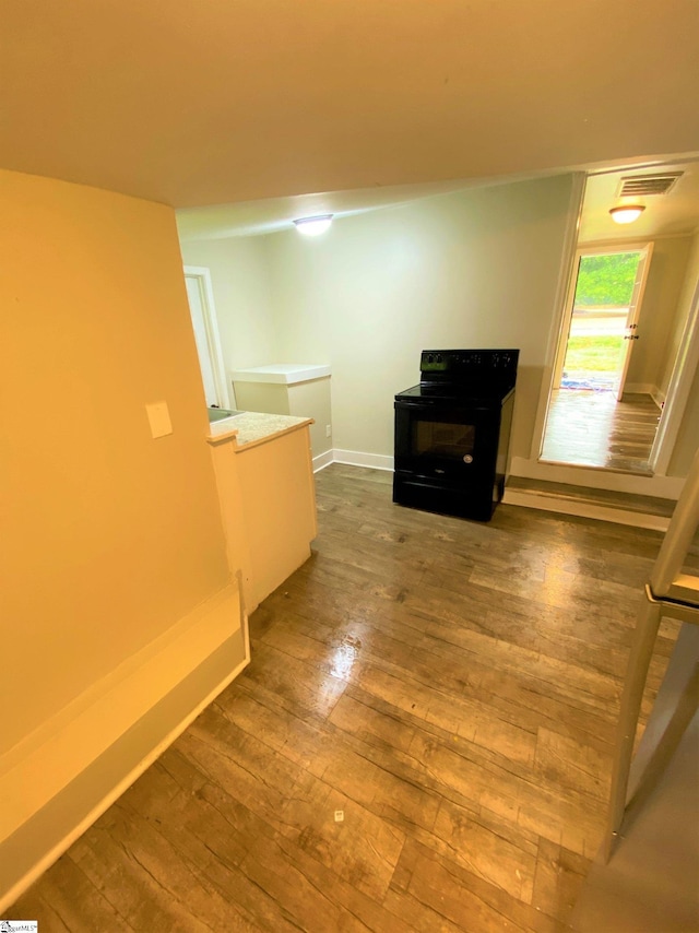 interior space featuring baseboards, visible vents, and hardwood / wood-style floors