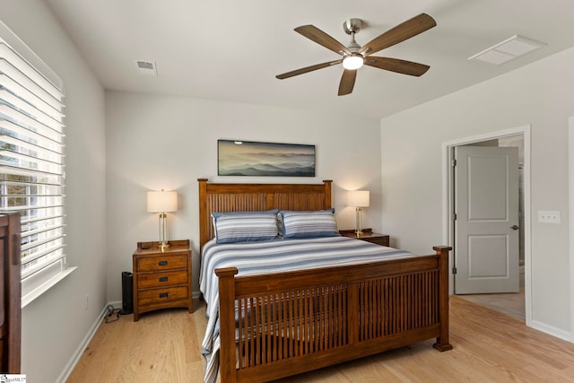 bedroom with light wood finished floors, baseboards, and visible vents