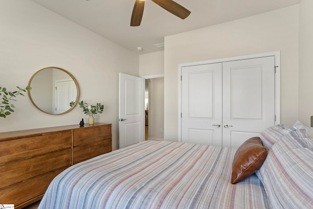 bedroom with ceiling fan and a closet