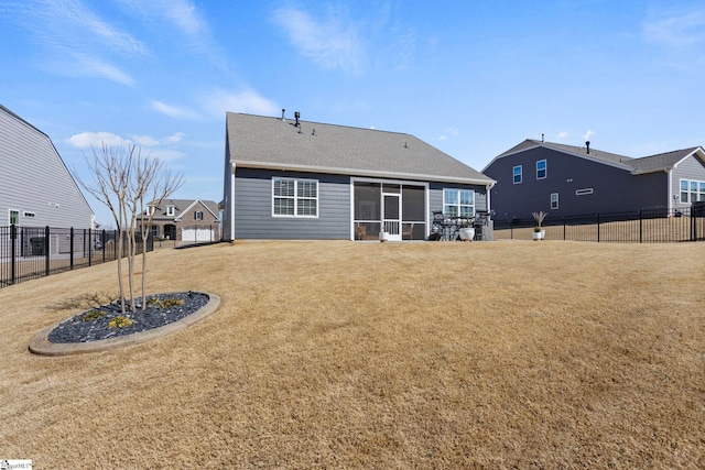 rear view of property with a yard, a fenced backyard, and a sunroom