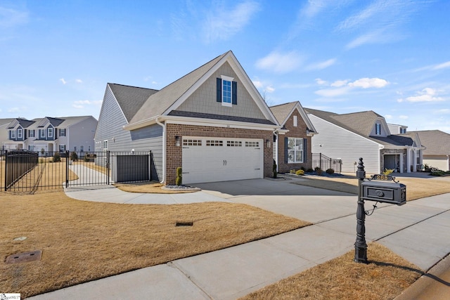 view of front of property with driveway, a garage, a residential view, fence, and brick siding