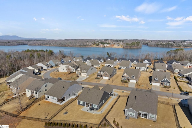 drone / aerial view featuring a water view and a residential view