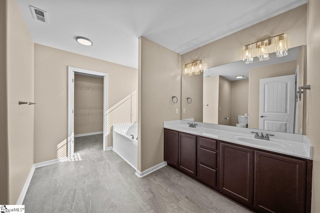 bathroom with toilet, visible vents, a sink, and a garden tub