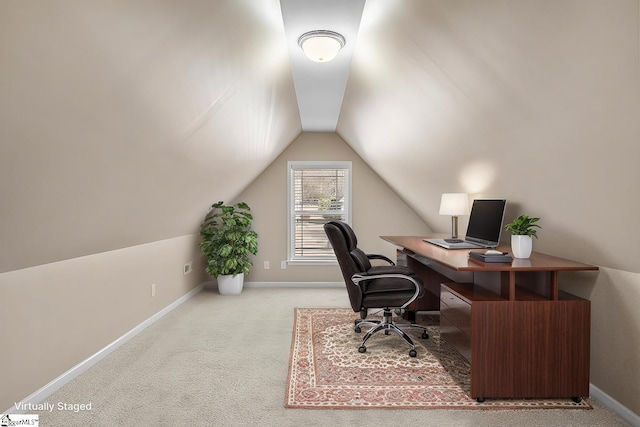 office featuring lofted ceiling, baseboards, and carpet flooring