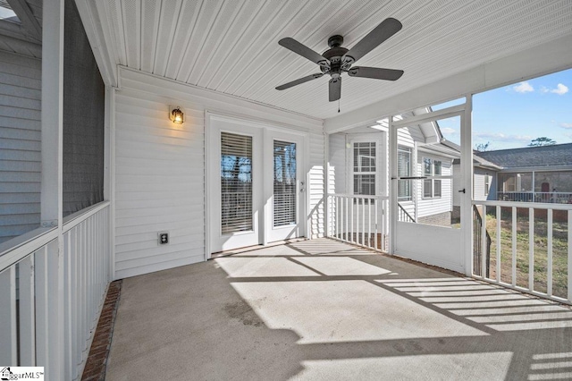 unfurnished sunroom with a ceiling fan