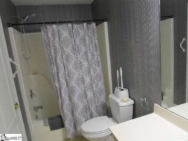 bathroom with shower / bath combo, vanity, and toilet