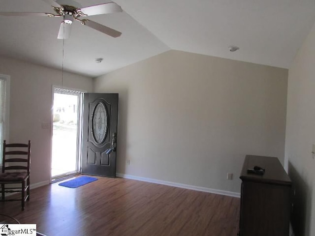 entryway with a ceiling fan, vaulted ceiling, baseboards, and wood finished floors