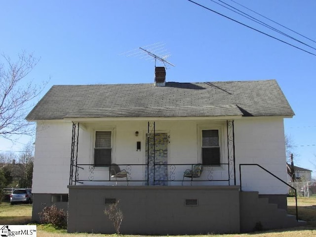 view of front of property with a porch and roof with shingles