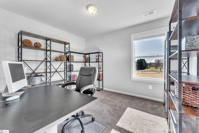 carpeted home office featuring visible vents and baseboards