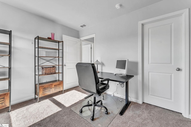 carpeted office space with visible vents and baseboards