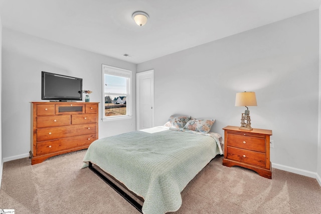 bedroom with carpet flooring, visible vents, and baseboards