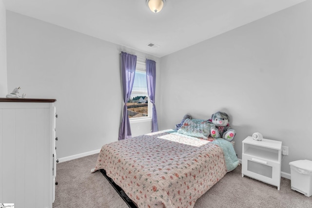 bedroom featuring carpet floors, visible vents, and baseboards