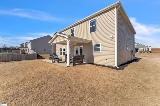 back of house with a patio, outdoor lounge area, fence, and a ceiling fan