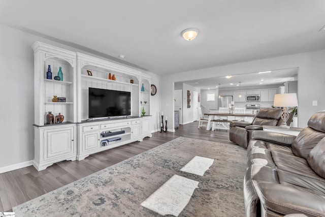 living room featuring dark wood-style flooring and baseboards