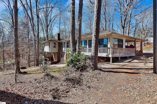 view of front of house featuring brick siding and a chimney