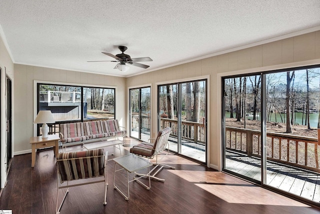 sunroom / solarium featuring a ceiling fan