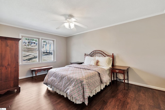 bedroom featuring crown molding, baseboards, and wood finished floors