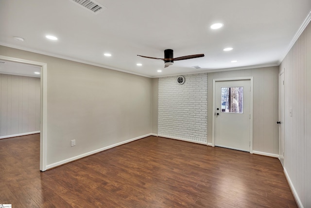 unfurnished room featuring crown molding, visible vents, a ceiling fan, wood finished floors, and baseboards