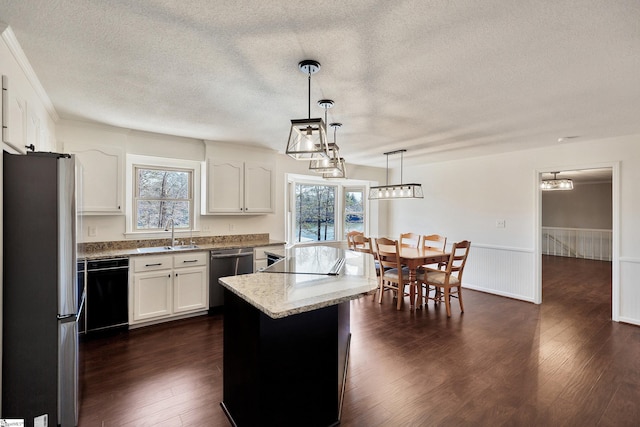 kitchen with a wainscoted wall, stainless steel appliances, dark wood-style floors, and white cabinets