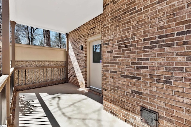 view of exterior entry with brick siding