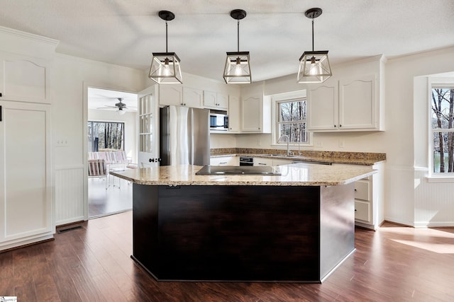 kitchen featuring appliances with stainless steel finishes, dark wood finished floors, white cabinetry, and crown molding