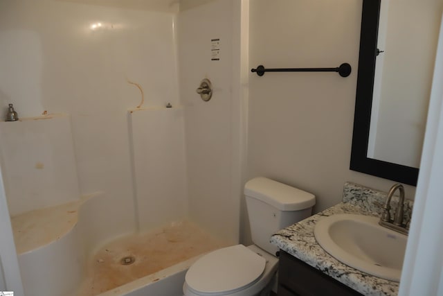 full bath featuring toilet, walk in shower, and vanity