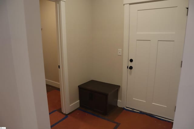 doorway to outside with baseboards