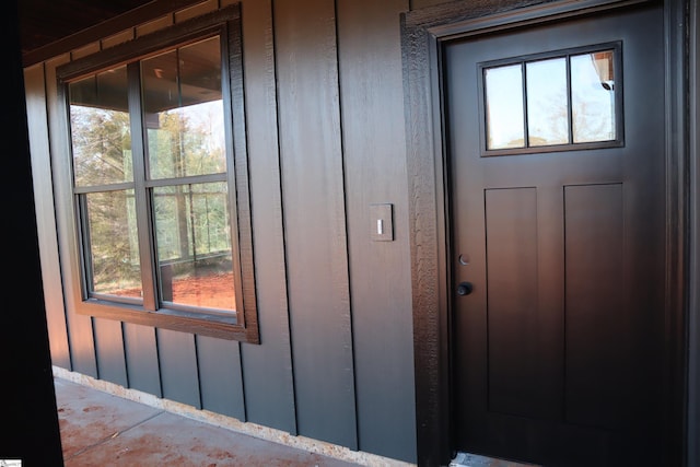 view of exterior entry with board and batten siding