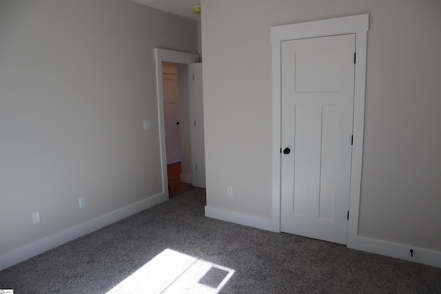 unfurnished bedroom featuring baseboards and carpet flooring