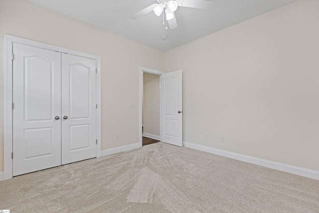 unfurnished bedroom featuring ceiling fan, a closet, carpet, and baseboards