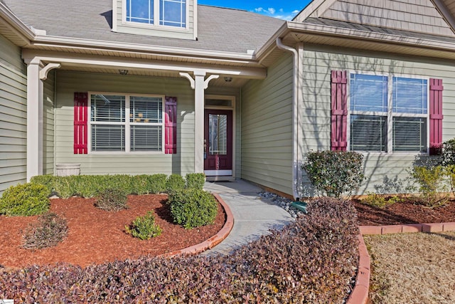 doorway to property featuring a shingled roof