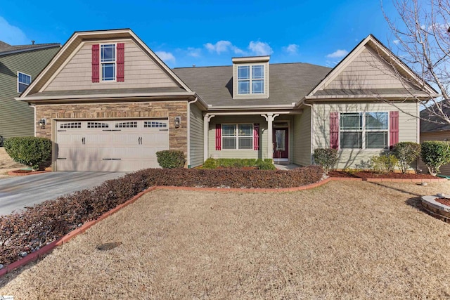 craftsman house with a garage, stone siding, and concrete driveway