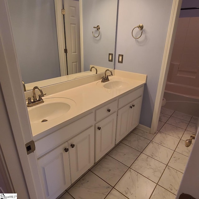 full bathroom featuring shower / washtub combination, marble finish floor, a sink, and double vanity