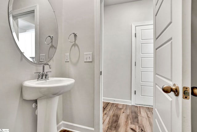 bathroom featuring baseboards and wood finished floors