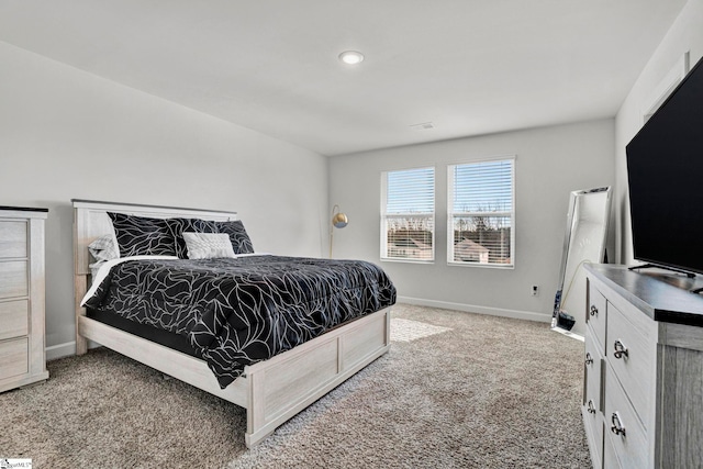 bedroom featuring light carpet and baseboards