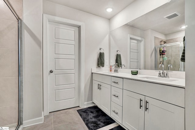 full bath featuring a stall shower, visible vents, a sink, and tile patterned floors