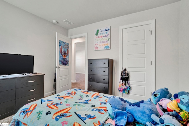 carpeted bedroom featuring visible vents and baseboards